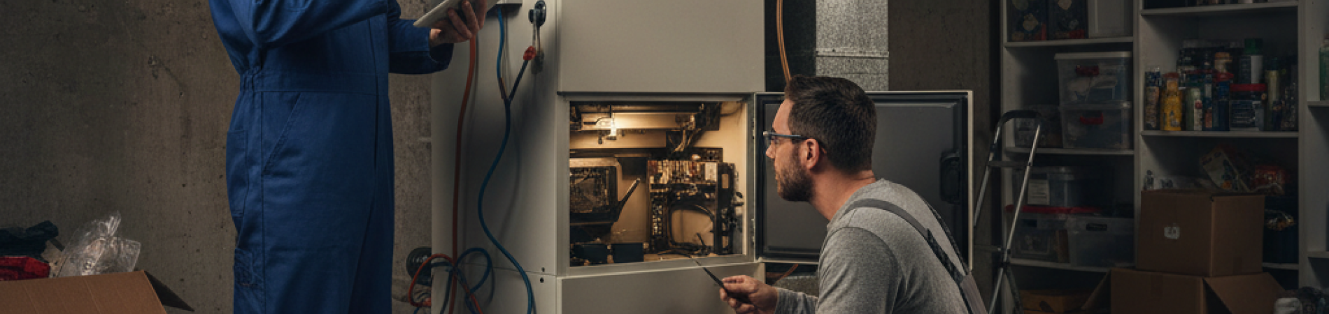 two men inspecting a furnace